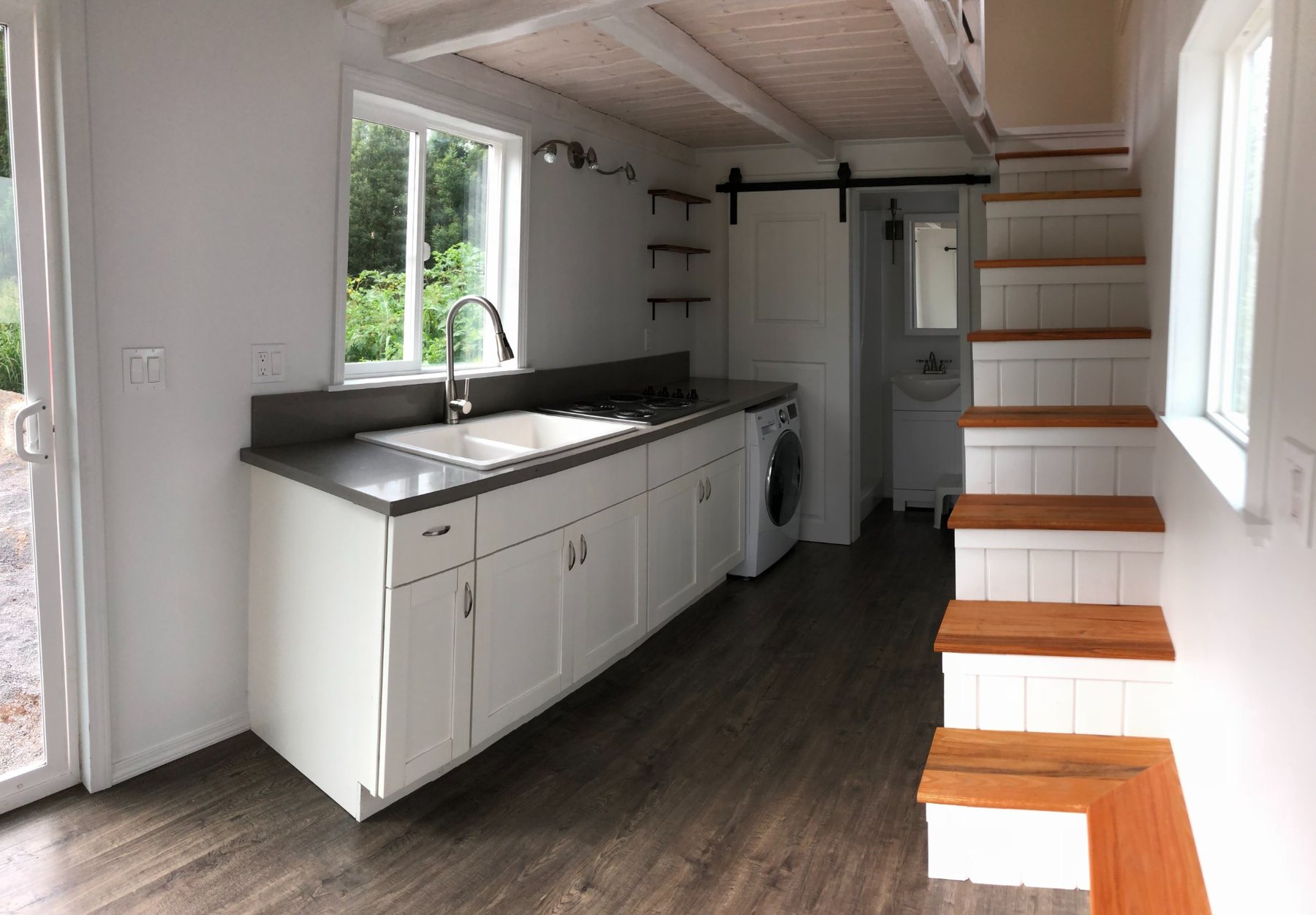 Finished compact home interior with custom stairs and cabinetry